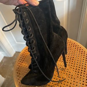 Black Steve Madden leather lace up pointed toe heel boots.
